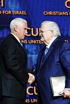 Pastor John Hagee (right) shakes the hand of Vice President Mike Pence at the CUFI summit in July.
