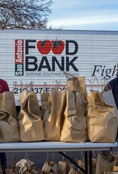 San Antonio Food Bank volunteers help hand out groceries.