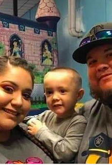 Mariah and Adan Gonzalez hold their boy, Raiden, who lost both parents to COVID-19.