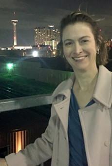 Luminaria executive director Kathy Armstrong takes a moment to enjoy the view from the Hays Street Bridge in Downtown East. Luminaria 2016 will take place in the eastside neighborhood this November.