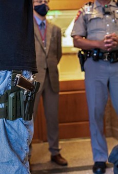 Two gun rights activists argue with a state trooper who will not allow them to enter an overflow room due to COVID-related restrictions at the Capitol on April 29, 2021.