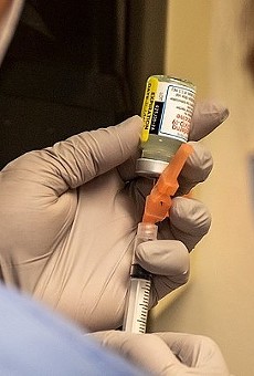 Hospital personnel prepare to administer a dose of Moderna's COVID-19 vaccine.