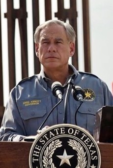 Gov. Greg Abbott puts on his best scowl and faux-military shirt at a photo-op showing off 900 feet of state-funded border wall.