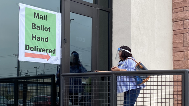 A voter drops off her ballot at the Bexar County Elections Office during the 2020 election.