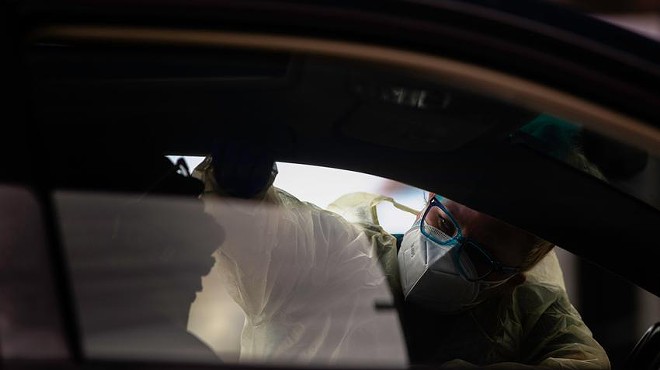 A nurse conducts a swab test for COVID-19 on a patient in a drive-thru station at the Austin Emergency Center at Mueller on Jan. 25, 2021. Since the fall, the CDC says there have been several new variants identified worldwide: A UK variant (B.1.1.7), a South African variant (B1.351) and a Brazilian variant (P.1).