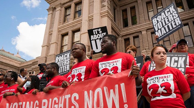 Individuals stand on the south steps of the Texas Capitol in support of voting rights at a press conference organized by Black Voters Matter, the Texas Right to Vote Coalition, Texas for All Coalition and other advocacy groups on July 8, 2021.