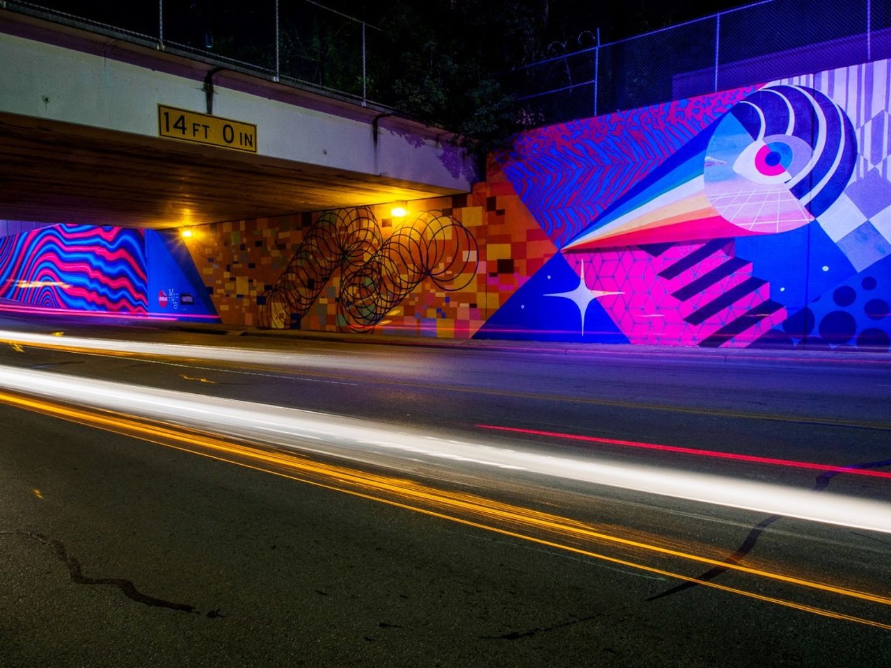 Neon Drive
401-405 Nolan St.
Artist: Iker Muro
A mural spanning 300 feet on the Nolan Street underpass, the art has an abstract focus on reflected light in a variety of colors. Created by Canary Islands-based artist Iker Muro, the mural complements another mural project on a different section of the underpass, by artist Alex Rubio.