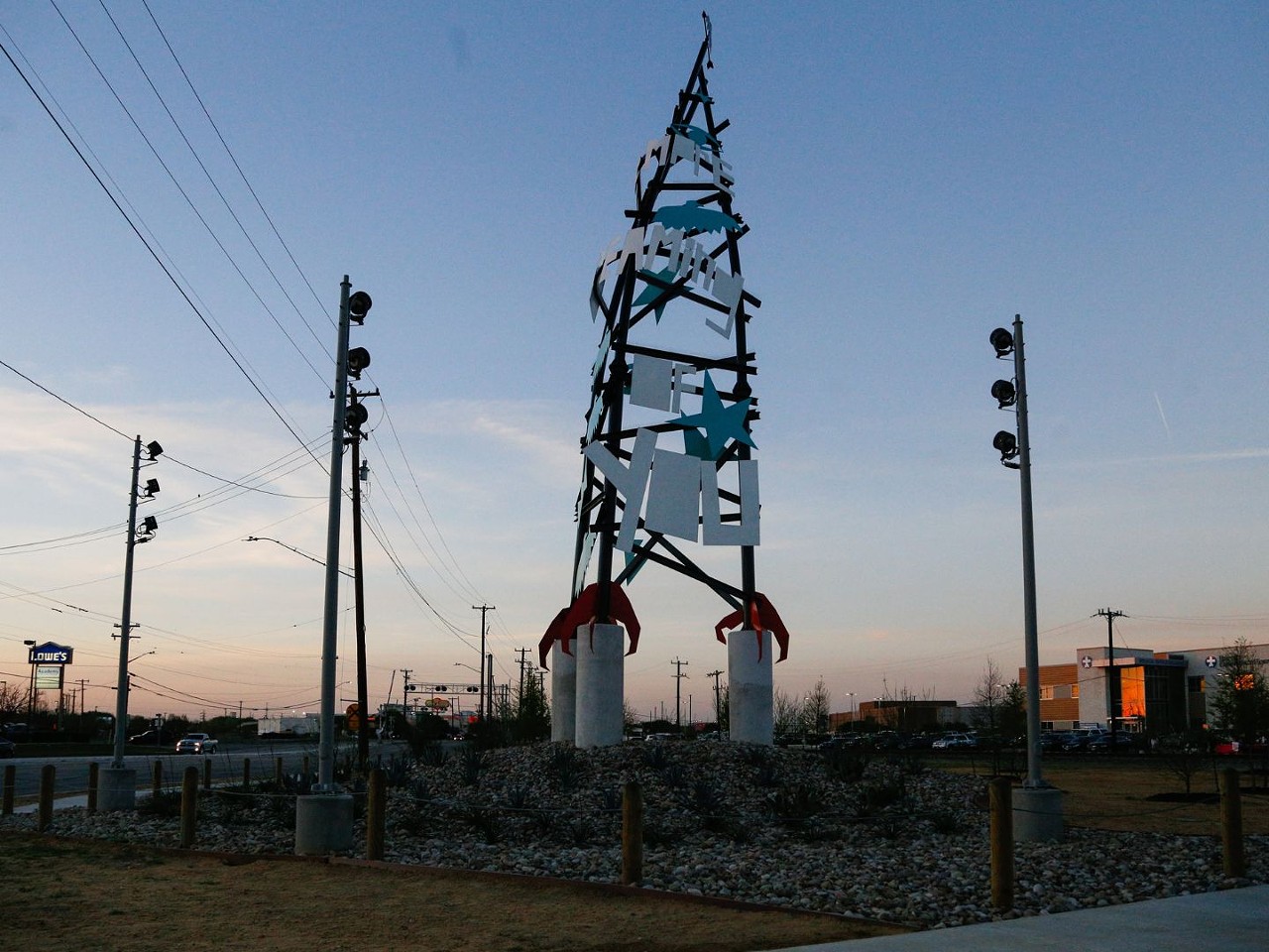 Dream Song Tower
I-35 Access Road at S. Zarzamora St.
Artist: Cruz Ortiz
Cruz Ortiz's dramatic sculpture recalls a strange hybrid of a radio tower, a rocket ship and a tepee tricked out with his graphic signatures and visual nods to Selena (the words “Siempre Dreaming of You”) and the urban legends of the Donkey Lady and the chicken-footed Dancing Devil.
