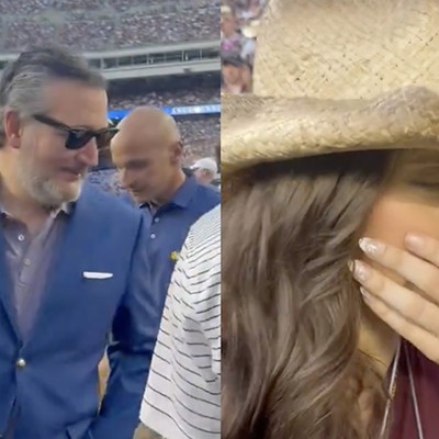 College football fan Lucy Rohden (right) pretends to be nauseated as U.S. Sen. Ted Cruz approaches her on the Texas A&M sidelines.